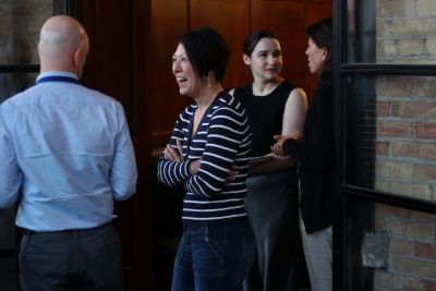 A person in a striped shirt laughs at the 2024 National Prosecution Best Practices Conference. 